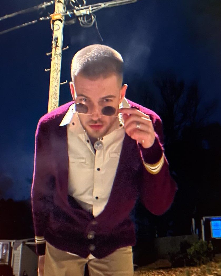 MerCureY at night in a maroon cardigan